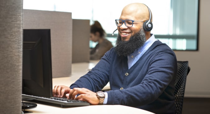 Male OnStar Advisor Smiling with Headset on